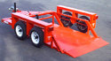 Red Triple L Trailer with its bed lowered to the ground