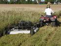 ATV pulling an AcrEase Pull Behind rough-cut mower