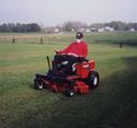 Man mowing with red snapper z-rider lawn mower