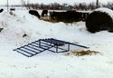 Plying on snow is the steel-tubing-constructed cattle guard, which consist of a ramp affixed on each side of an elevated rectangular frame w/ tubing across the top.