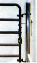 Hinged to the gate post is the gate having affixed to its vertical end-frame a length of spiral spring clamped near the bottom and near the top running across to a length of chain hanging from a hook on the post.