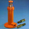 The tractor-hydraulic-system-powered jack is shown along with two NPT female adapters.