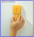 An adult male hand holds the device to a white wall, allowing it to respond as described.