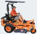 Orange zero-turn mower facing right driven by a man in gray shorts and button-down orange shirt with camouflage baseball cap and with a canopy over his head attached to the ROPS bars.