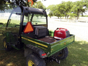 Pic of John Deere Gator with red Honda generator in back connected to air conditioner that blows into back of the Gator cab.