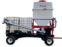 4-wheel cart with tongue that has 2 white rectangular liquid hoppers on the back and a larger feed-type hopper on the front