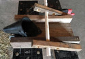 Table with homemade wood castration station mounted on it along with plastic black funnel for holding the piglet's head