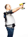 Man holding drill gun with arm extended upward with Eksosuit fastened to back - arm - and waist.