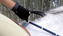 Person wearing black glove holding the Correct-Connect Reins on the back of a white horse.