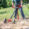Man digging a hole in the ground with an Earth Auger Torque Reducing Tool.