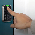 A hand with the index finger on a Fingerprint-Enabled Door Lock
