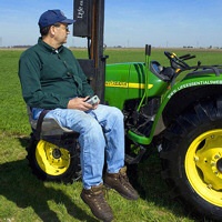 Farmer with a disability uses a lift to get in his tractor