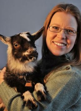 portrait of Shea Rolnick holding a goat