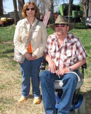 Michael sitting in wheelchair with Rebecca standing next to him