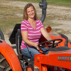 Sara Creech driving tractor