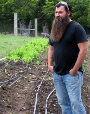 James Jeffers standing in front of urban farm patch