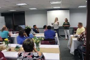 Photo of classroom setting with two women instructing at front of class