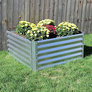 Galvanized steel panels attached in square to form raised garden bed with flowers growing