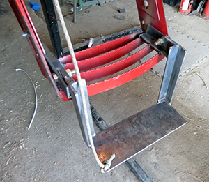 Homemade extra steps attached to tractor steps with rope to pull it upward