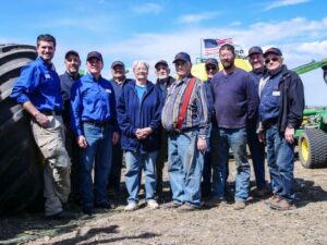 Bill Gross, third from left, with Farm Rescue volunteers and a family they helped