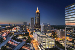 Midtown Atlanta at night with tall buildings and highways