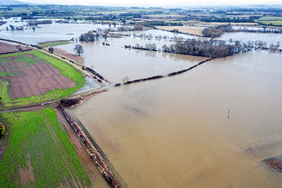 Farming fields in flood surrounding River Severn after Storm Dennis in Shropshire, United Kingdom - drone point of view