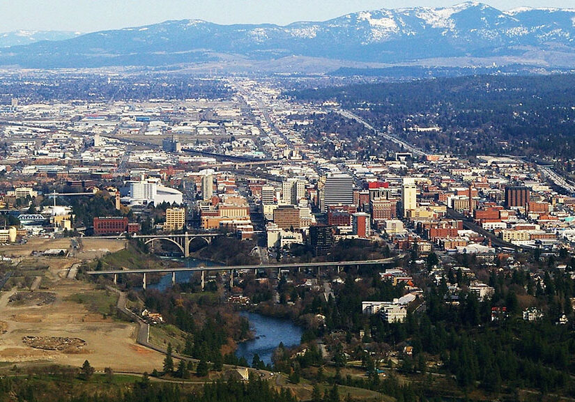 Aerial view of Spokane downtown with mountains in background